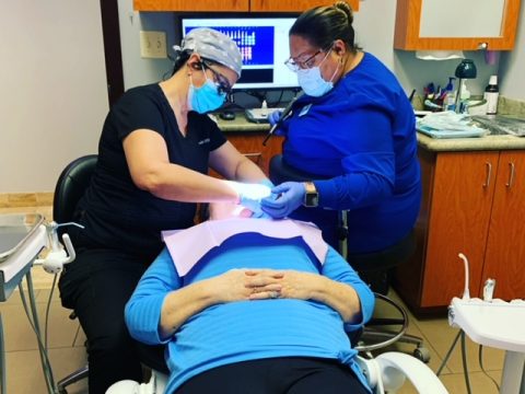 Dentists using advanced technology to provide treatments to a patient
