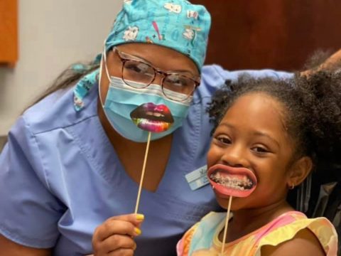 A friendly dentist with a child patient