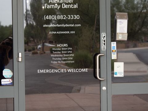 Alexander Family Dental Clinic entrance with contact info and hours