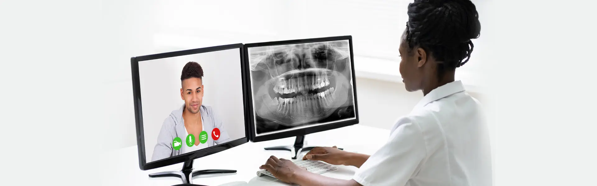 Dentist reviewing X-ray on monitor